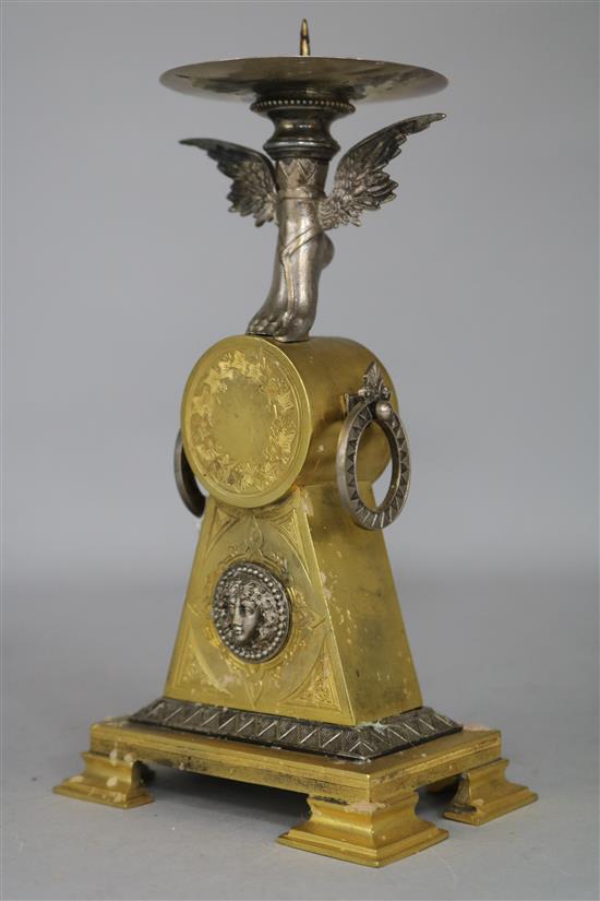 An Empire style ormolu candlestick